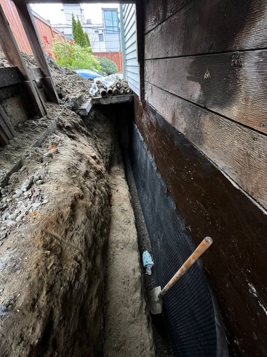 Completed basement waterproofing drainage system installed by Basement Expert