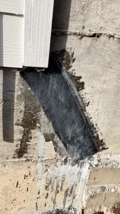 Close up view of a moderate foundation crack after the process of carbon fiber reinforcement Seattle's project