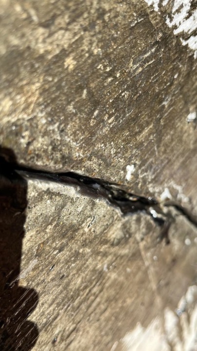 Close up view of a moderate foundation crack in the process of carbon fiber reinforcement Seattle's project