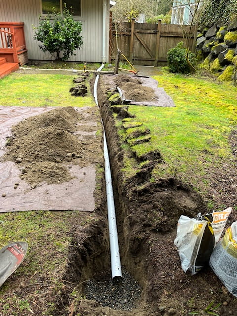 Everett WA, Downspout Redirecting System and yard drain laying down through the yard