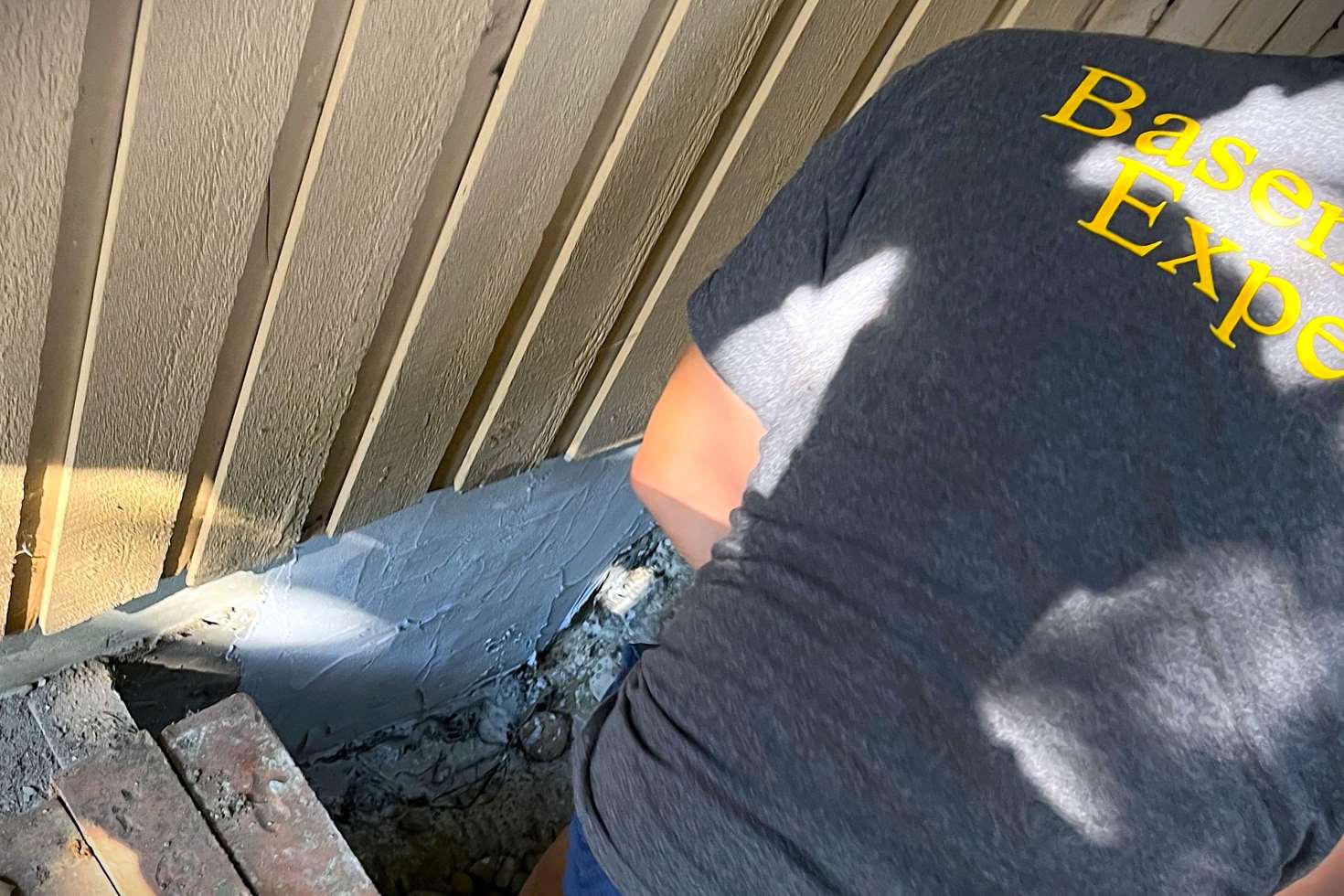 Foundation Repair in Shoreline, WA by Basement Expert. Certified technician is fixing foundation wall with a carbon fiber and cement patching 10,000psi strenght 2