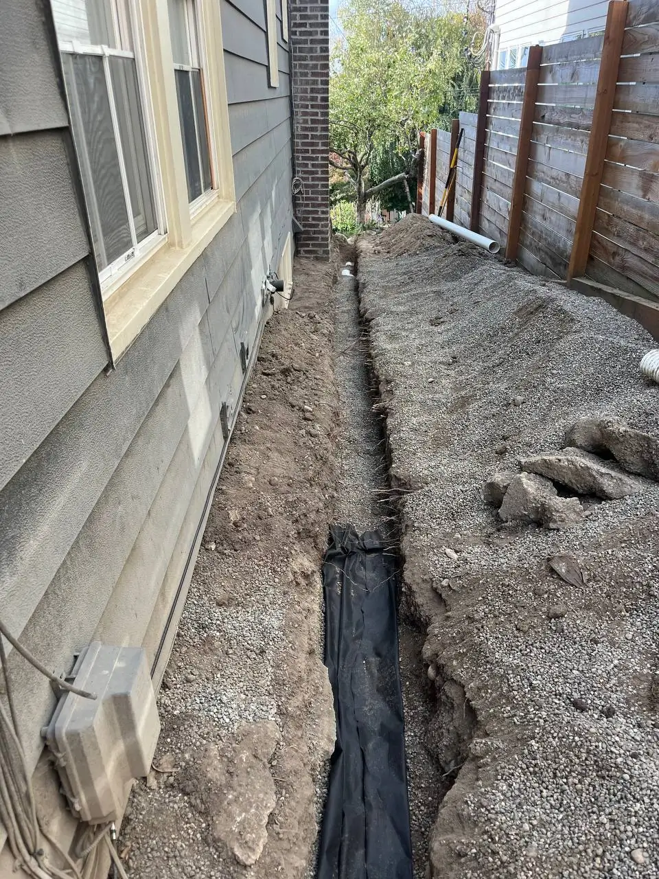 deep-trench-with-filter-fabric-and-pvc-drain-arlington-wa Foundation drainage and waterproofing work by Basement Expert