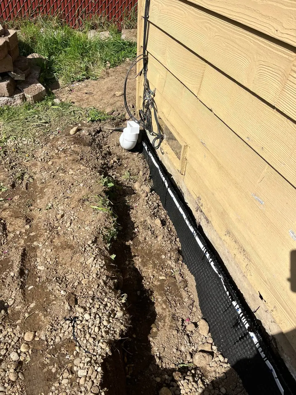 Excavation trench for exterior footing drain installation